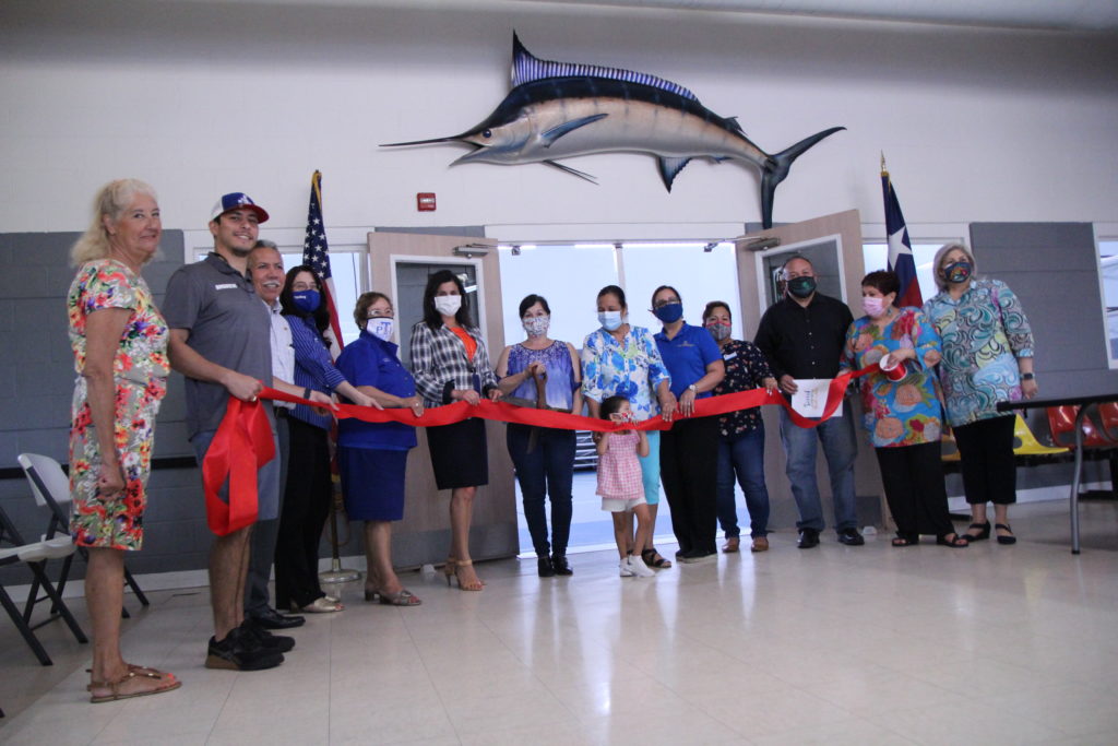 Laguna Madre area city representatives and Laguna Madre Youth Center staff during a ribbon cutting ceremony celebrating the reopening of the Laguna Madre Youth Center.