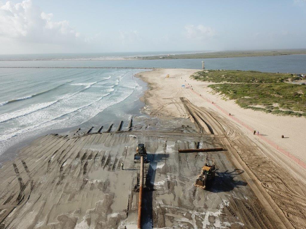 Dredged sand being added and flattened on Isla Blanca Park on June 26.