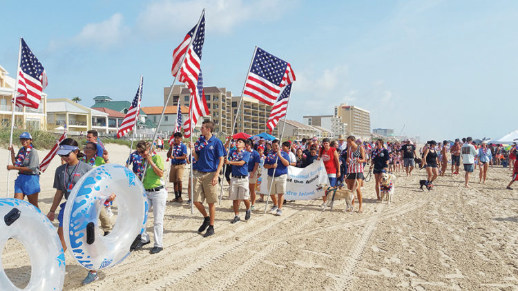SPI’s 4th of July beach parade marches down the city’s beach in 2018. 