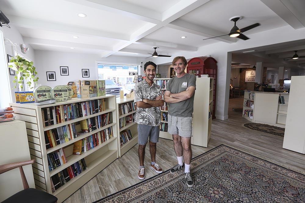 Co-owners Roin Khurami and Will Everett stand in the center of their new business, Karma Coffee and Books Friday on South Padre Island. (Denise Cathey/The Brownsville Herald)