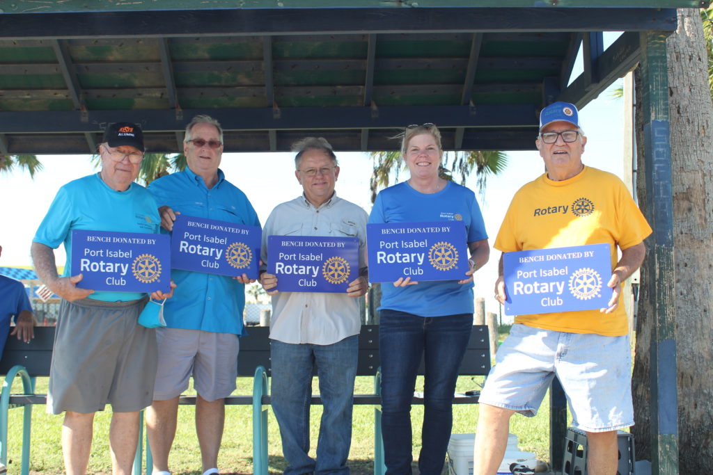 Members of the Port Isabel Rotary Club pose with metal placards that are now affixed to benches the club purchased for Island Metro stops in Port Isabel and Laguna Heights. Photo by Gaige Davila.
