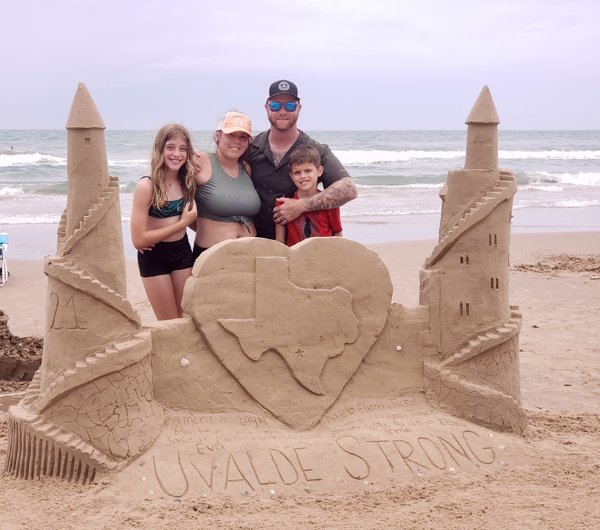 Students build sand castle with prominent message
